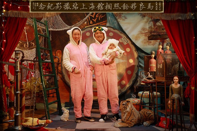 A couple wearing matching outfits with their baby